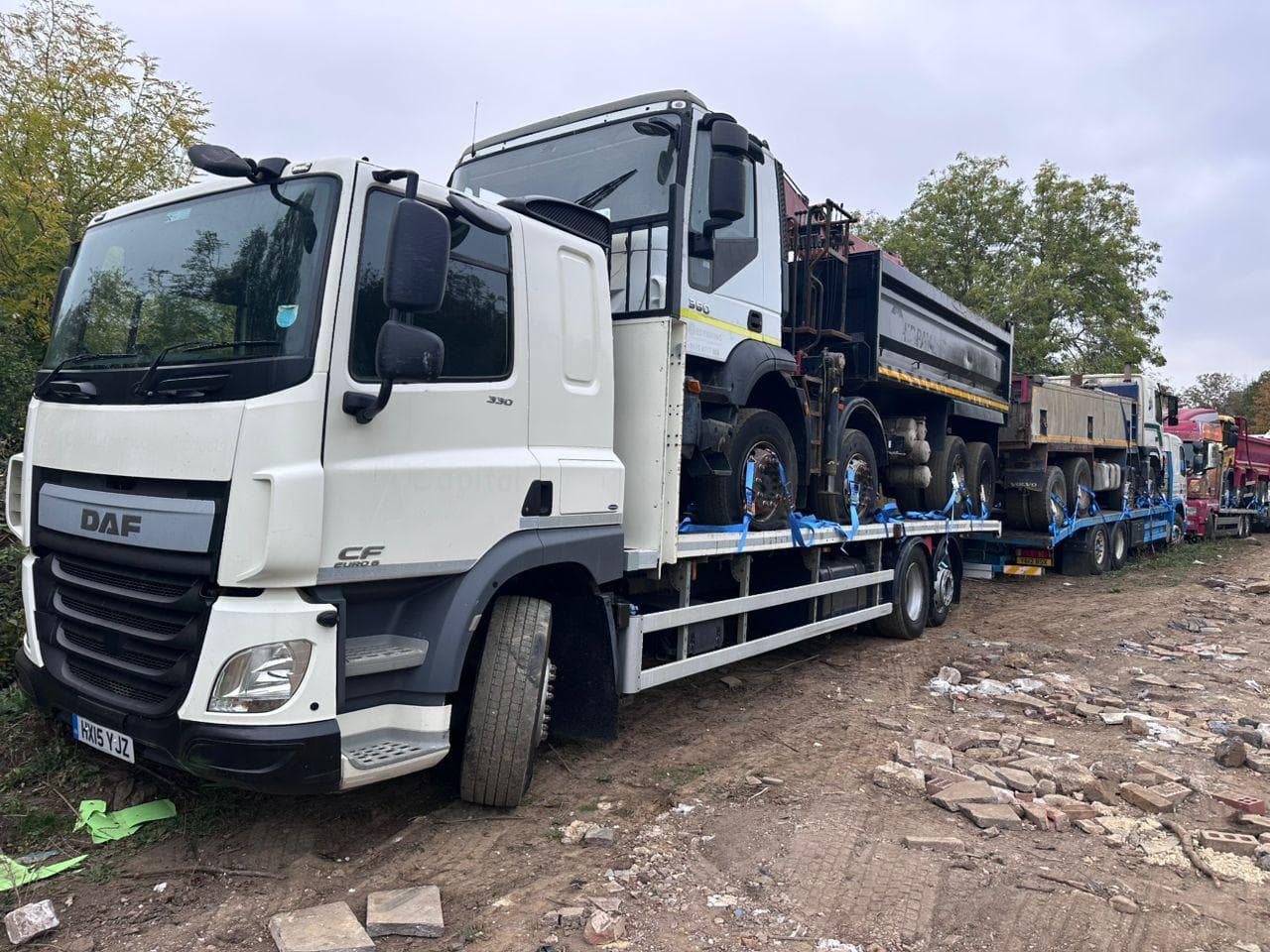 Commercial trucks prepared for onward transport